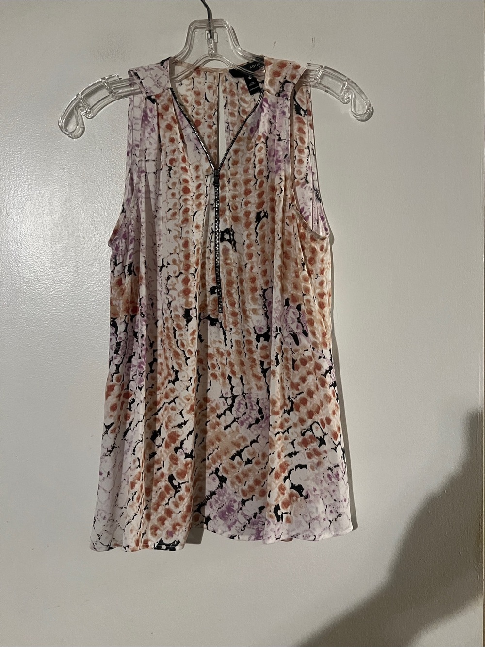 Aqua sleeveless flowy zip front blouse.